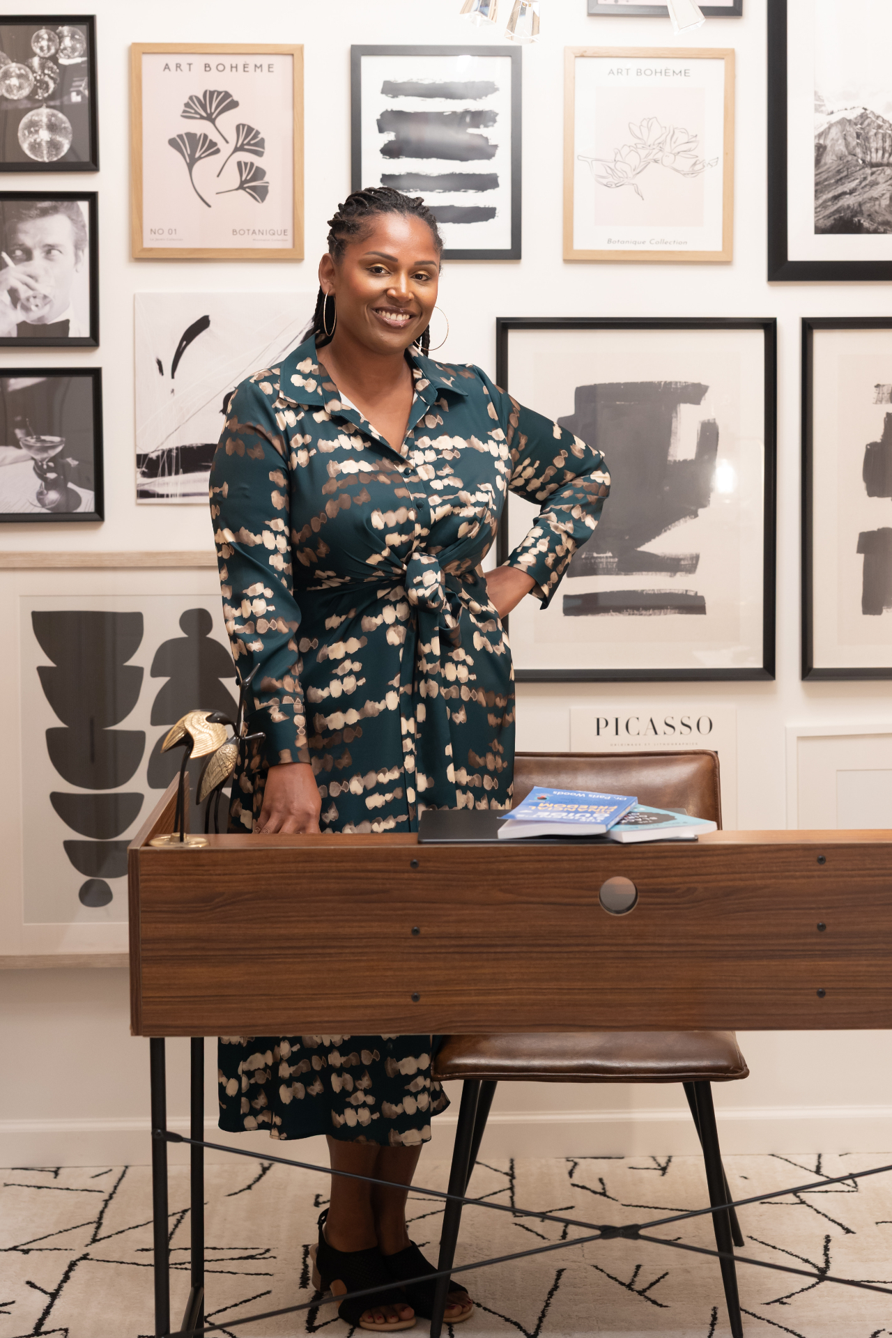 Dr. Paris Woods at her desk with her books